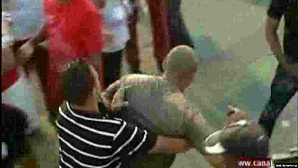 El opositor es entregado a otro agente vestido de civil fuera del área restringida/ foto cortesía de video RCN TV